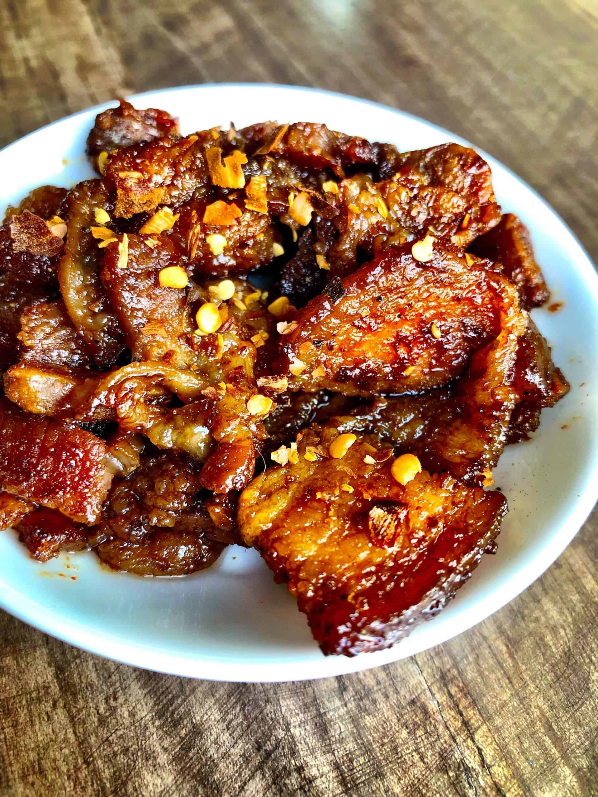 sweet and spicy keto pork belly in a white bowl