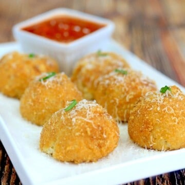 plate with 6 air fryer arancini and dipping sauce