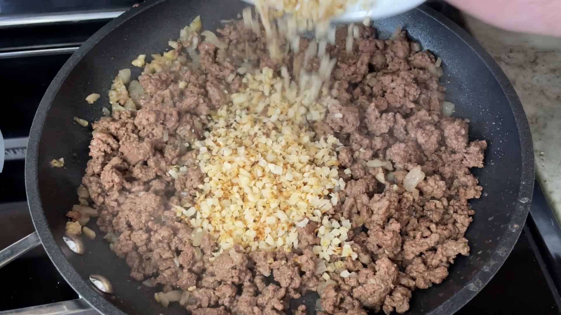 adding cauliflower rice to ground meat