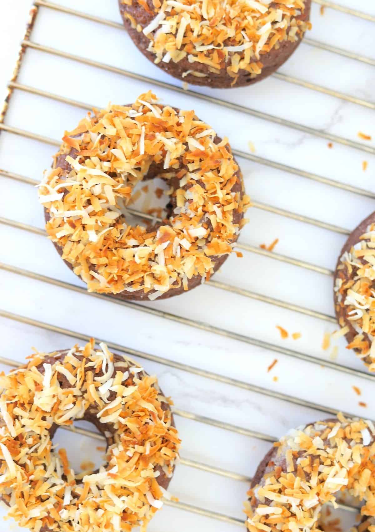 toasted coconut doughnuts on cooling rack