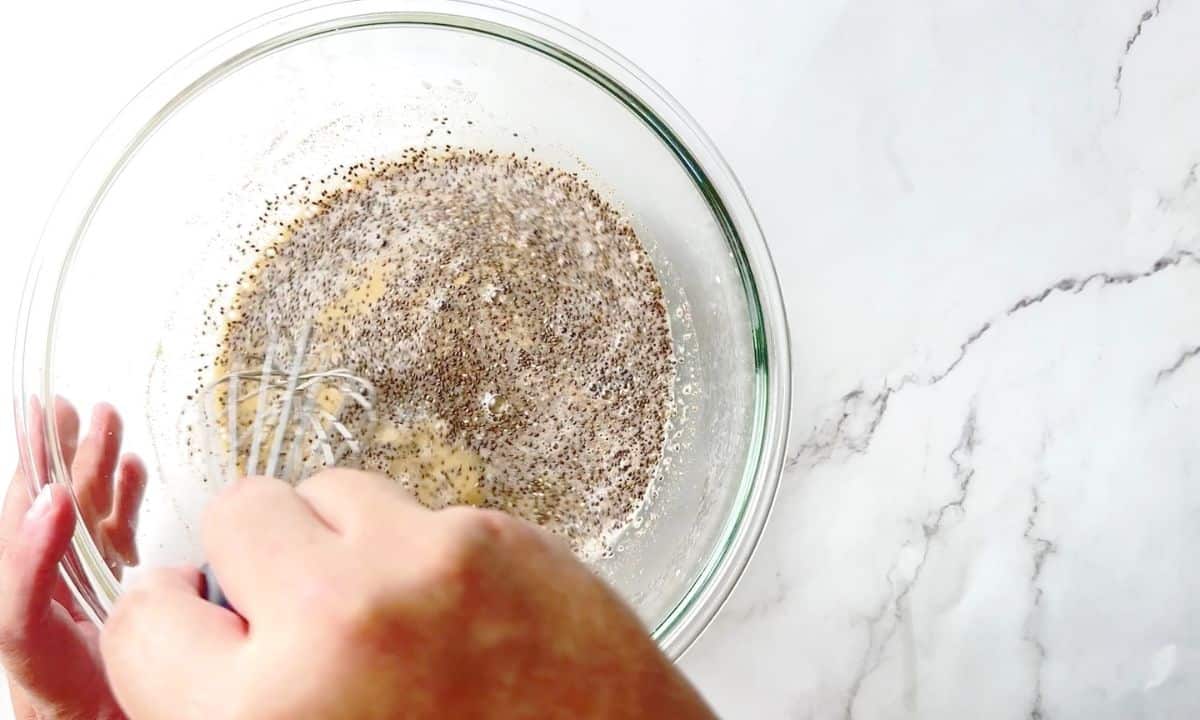 mixing the chia pudding ingredients with a whisk.