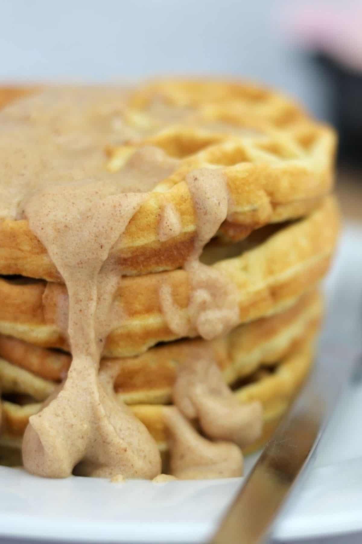 stack of sugar free waffles with a cinnamon cream cheese icing.