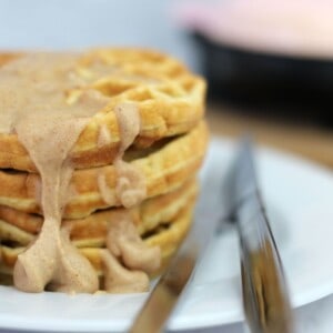 stack of sugar free waffles with a cinnamon cream cheese icing.