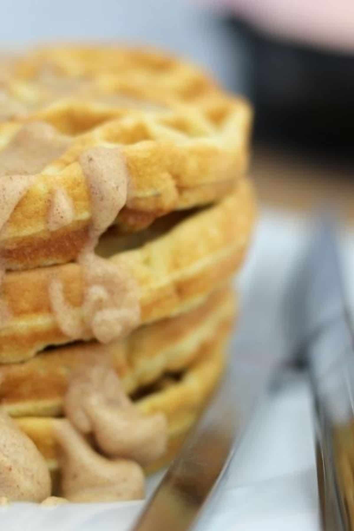 stack of sugar free waffles with a cinnamon cream cheese icing.