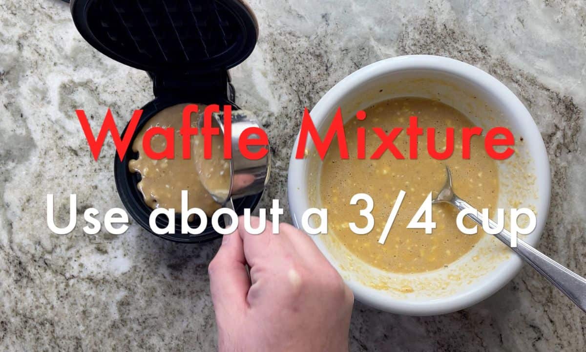 adding the waffle mixture to the waffle iron.