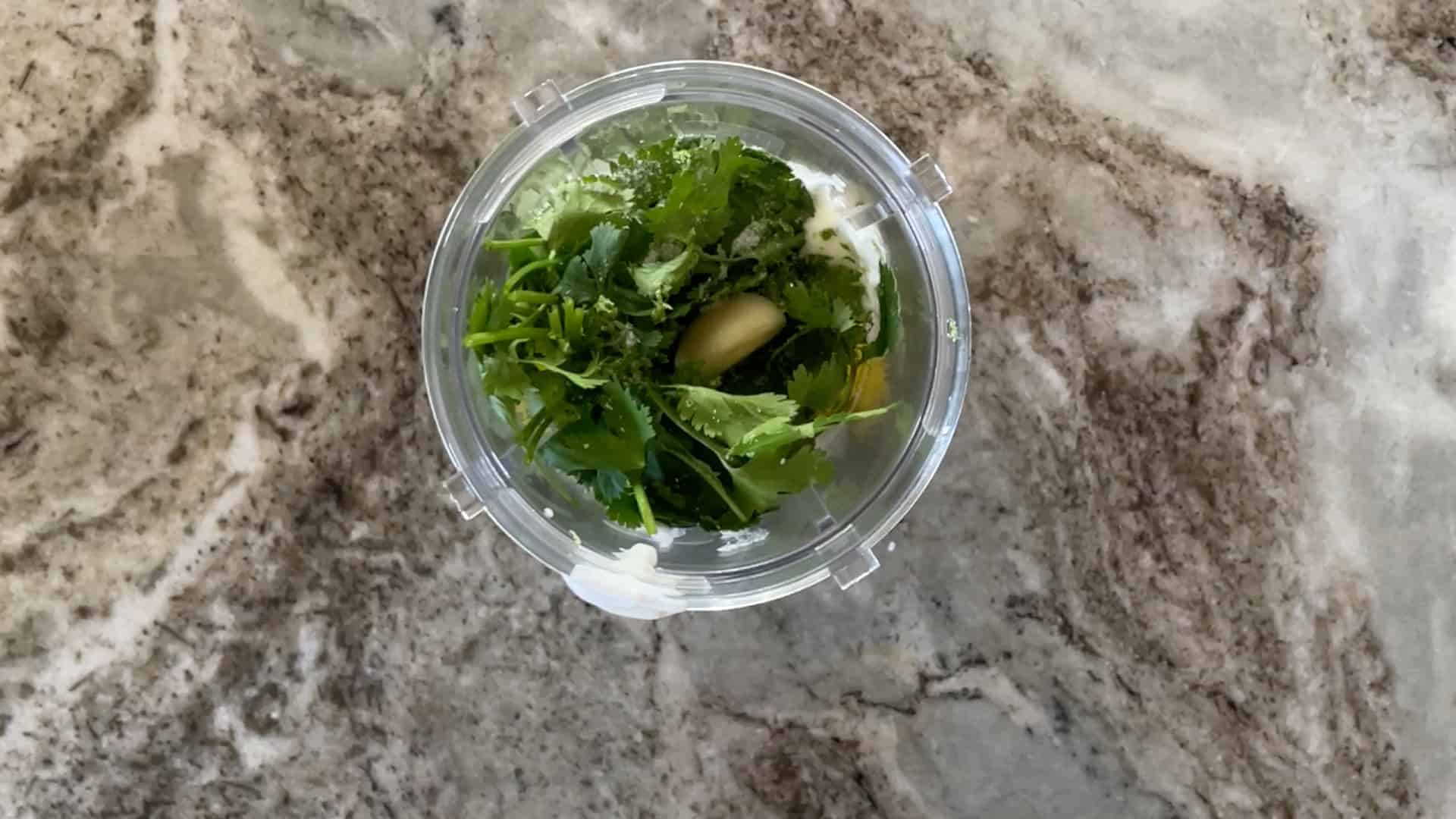 ingredients in a blender cup for cilantro lime aoli
