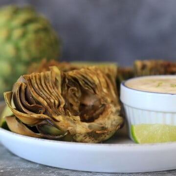 air fried artichokes ona plate with dipping sauce