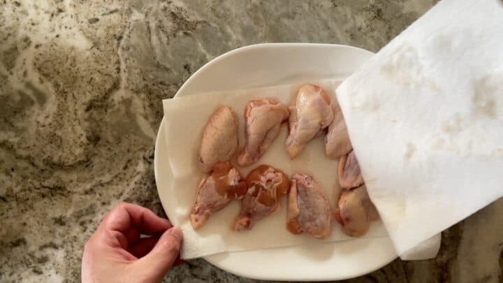 drying the chicken wings with paper towels