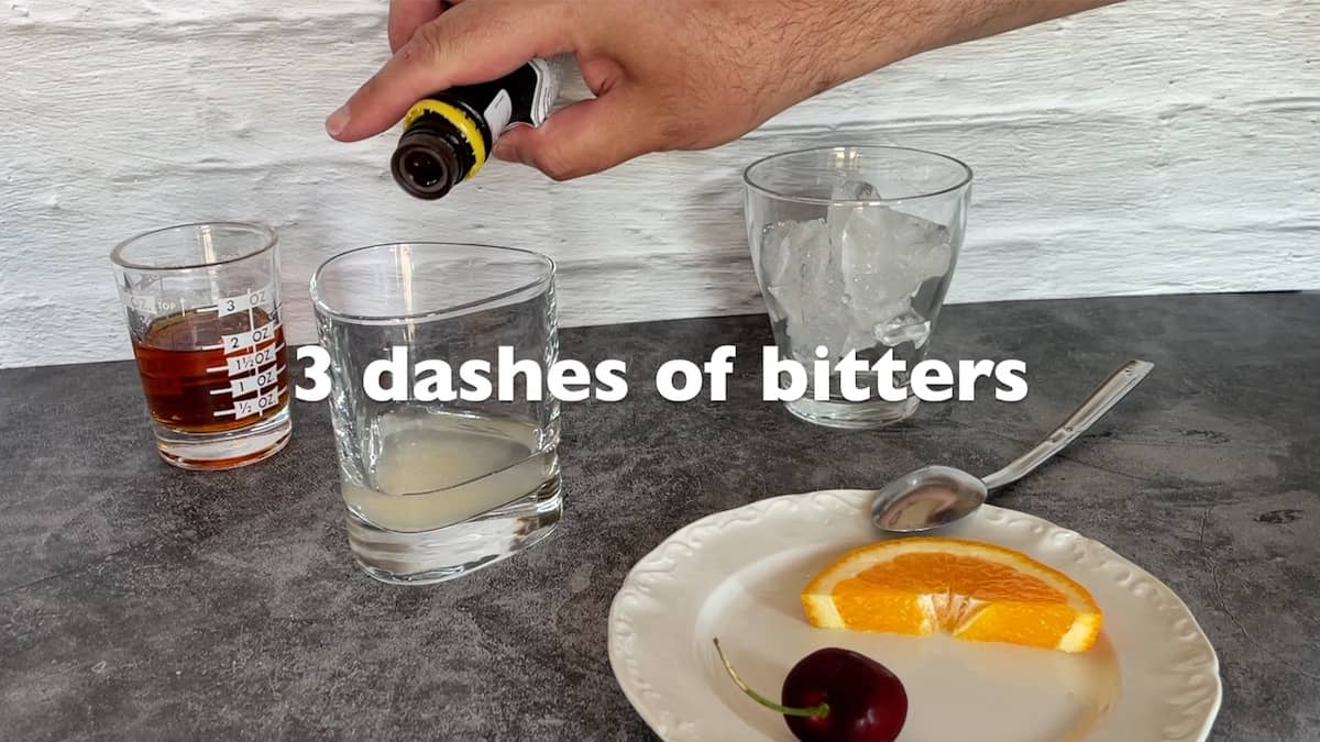 adding 3 dashes of bitters