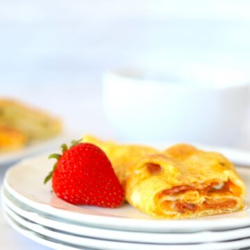 egg roll up on a plate with a strawberry