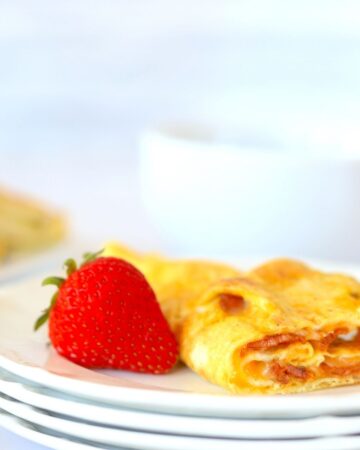 egg roll up on a plate with a strawberry