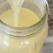 pouring simple syrup into a mason jar