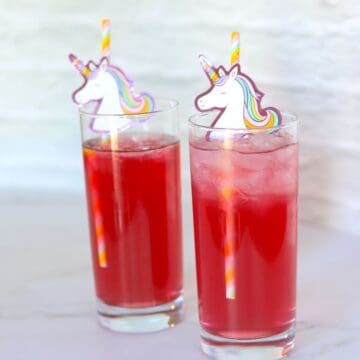 two unicorn cocktails with unicorn straws