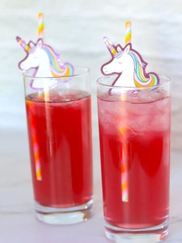 two unicorn cocktails with unicorn straws