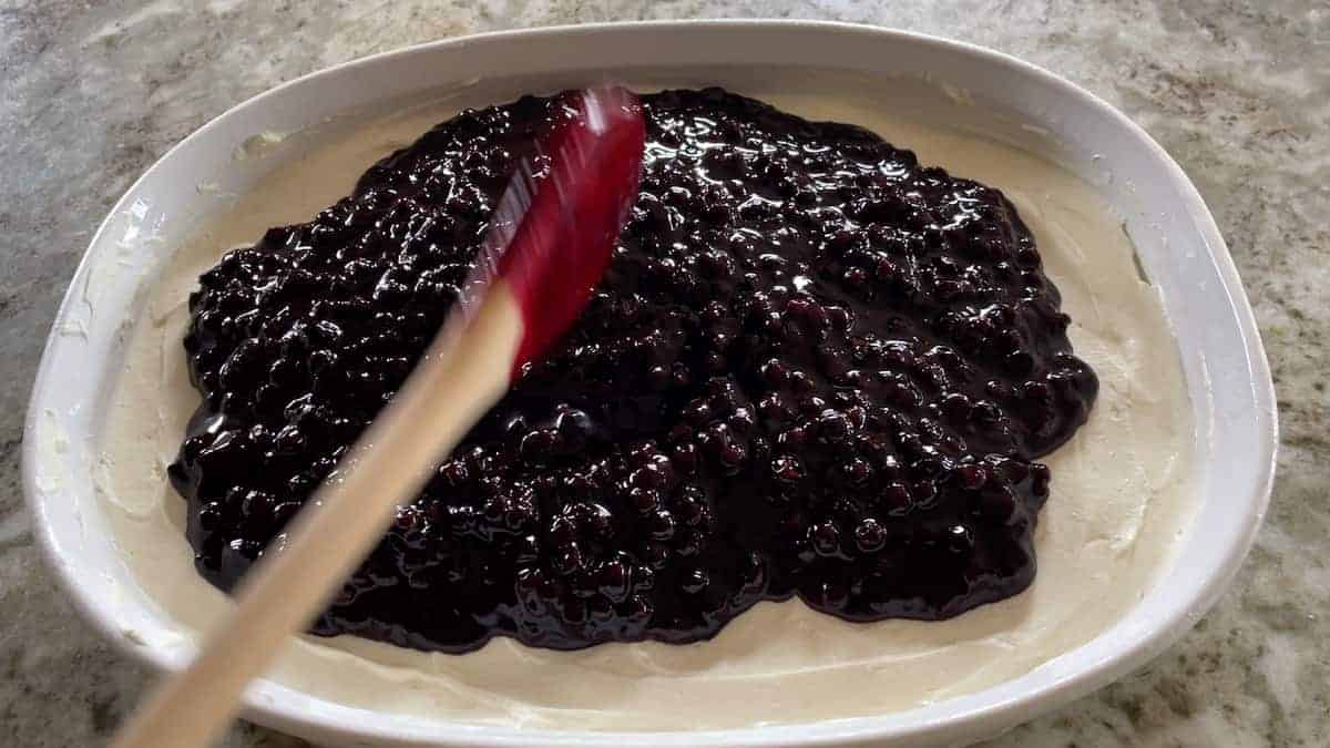 spreading the blueberry filling over the cream cheese mixture.