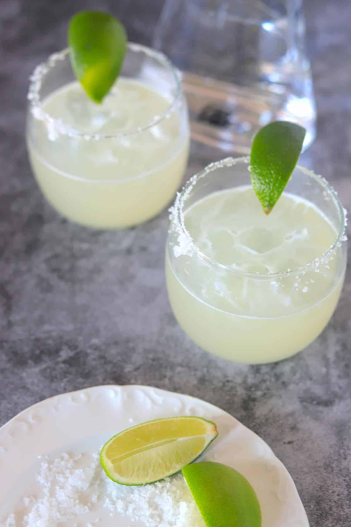 2 Margarita Low Carb Sugar Free glasses with a salt plate and lime wedges