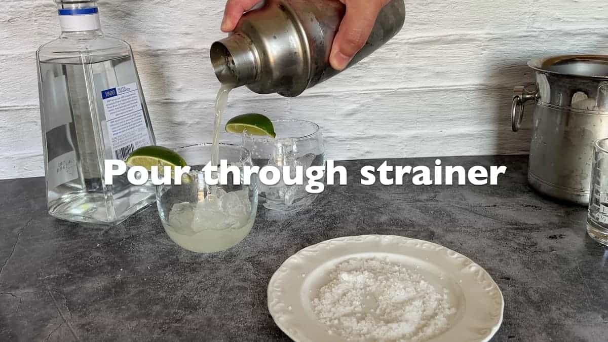 Pouring the tequile through strainer