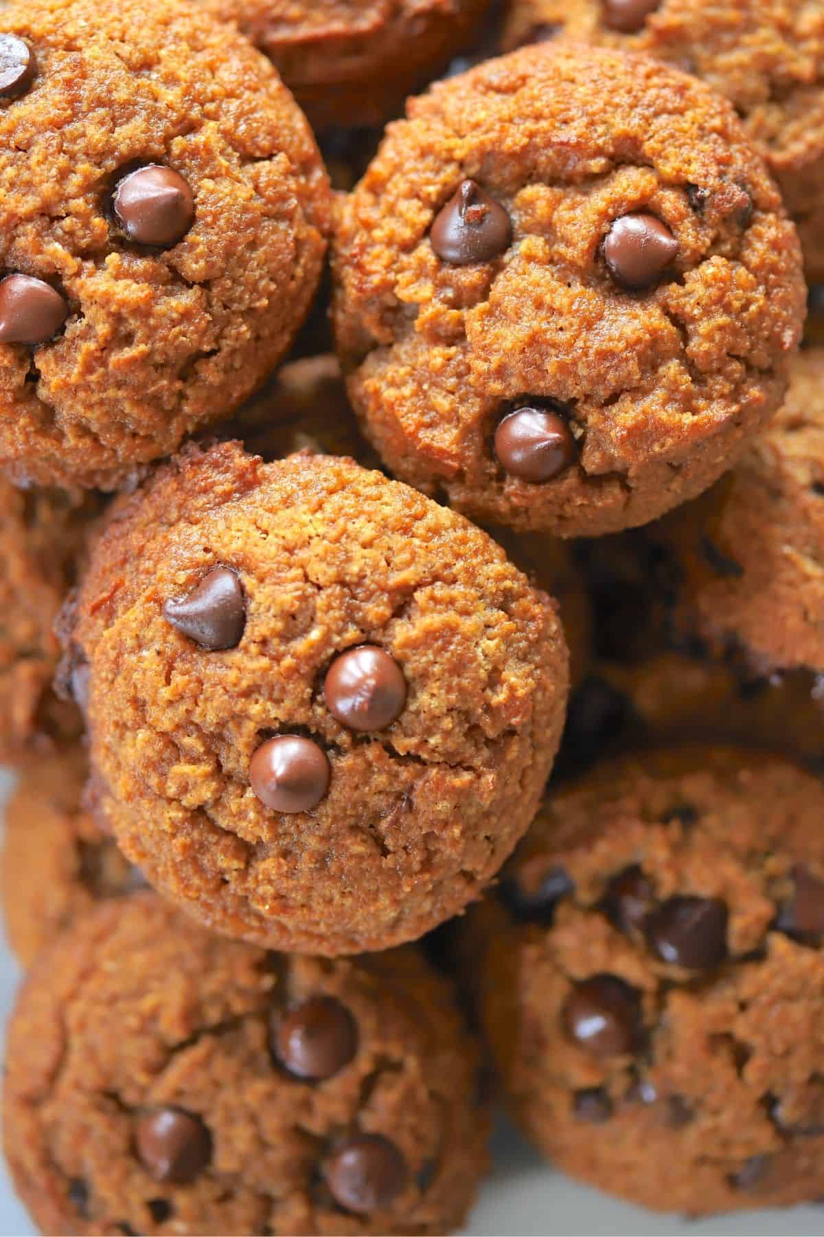 baked pumpkin cookies piled on a plate on top of each other