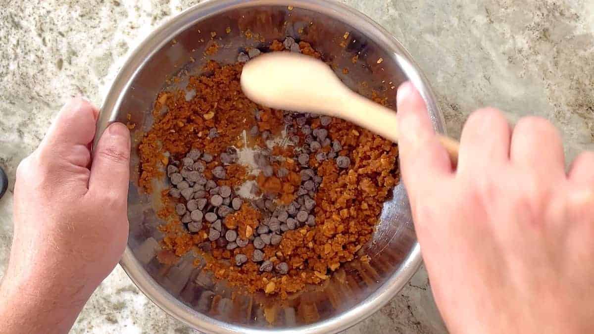 Mixing in the chocolate chips into the cookie dough
