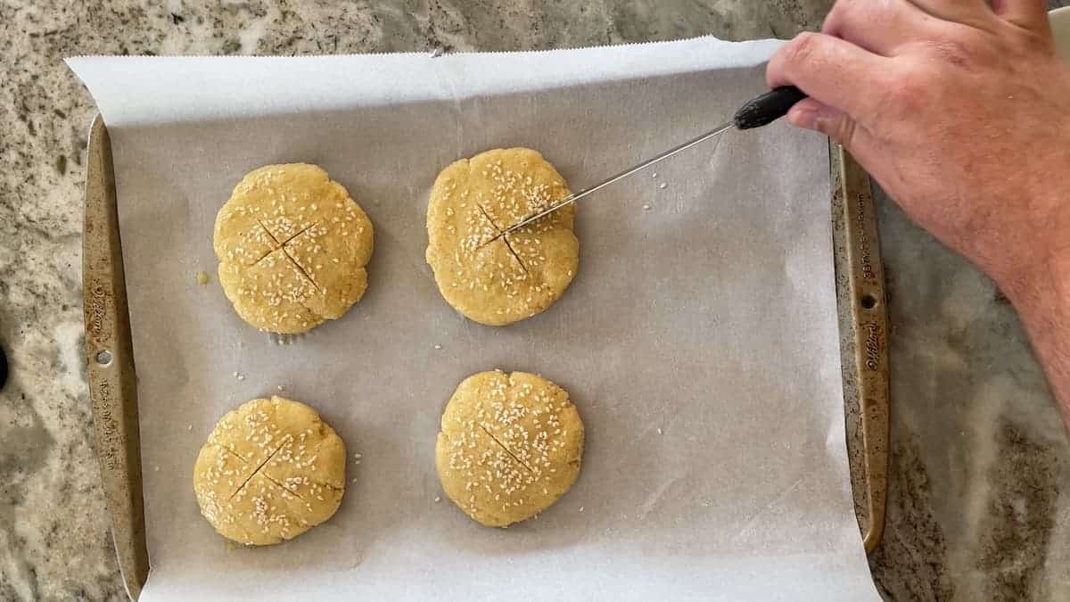 scoring the tops of the dough with a knife