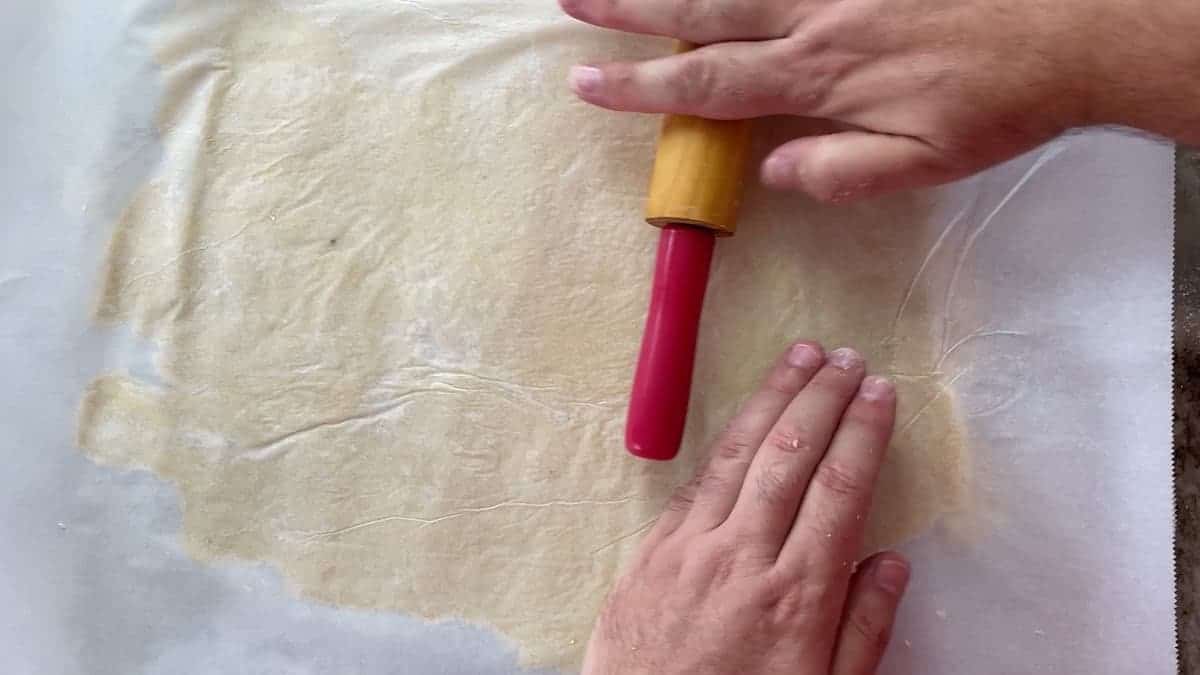 Rolling dough on a parchment sheet