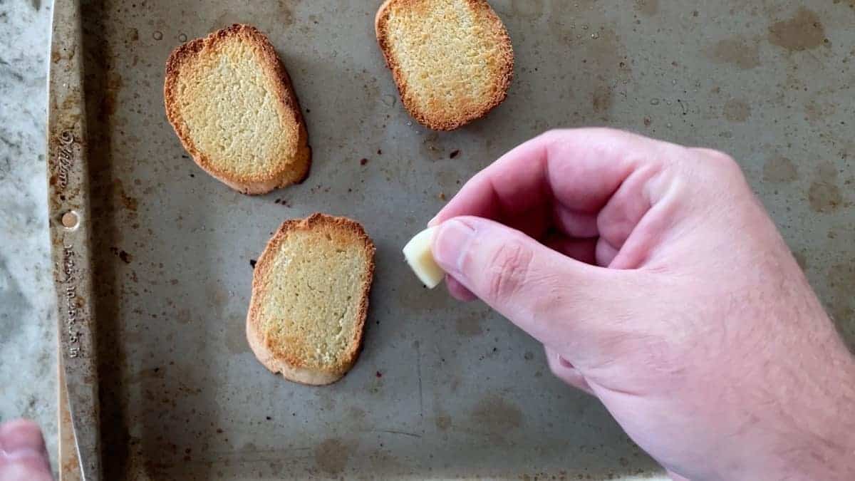 brushing the baguettes with garlic