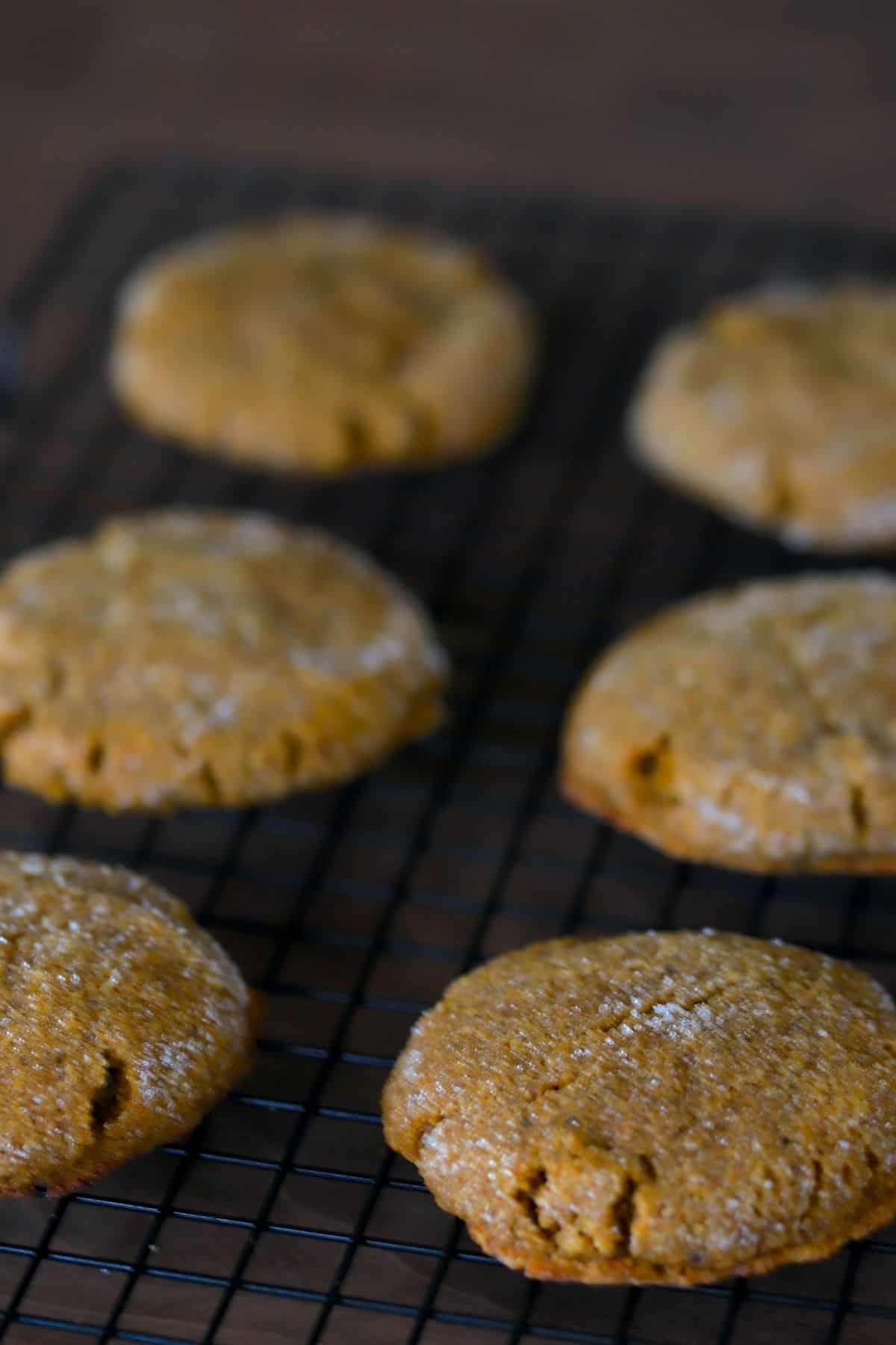 six pumpkin spice cookies laying flat on a cooling rack