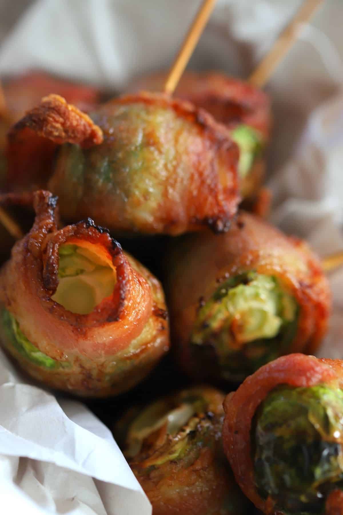 brussel sprouts wrapped in bacon with a toothpick inserted