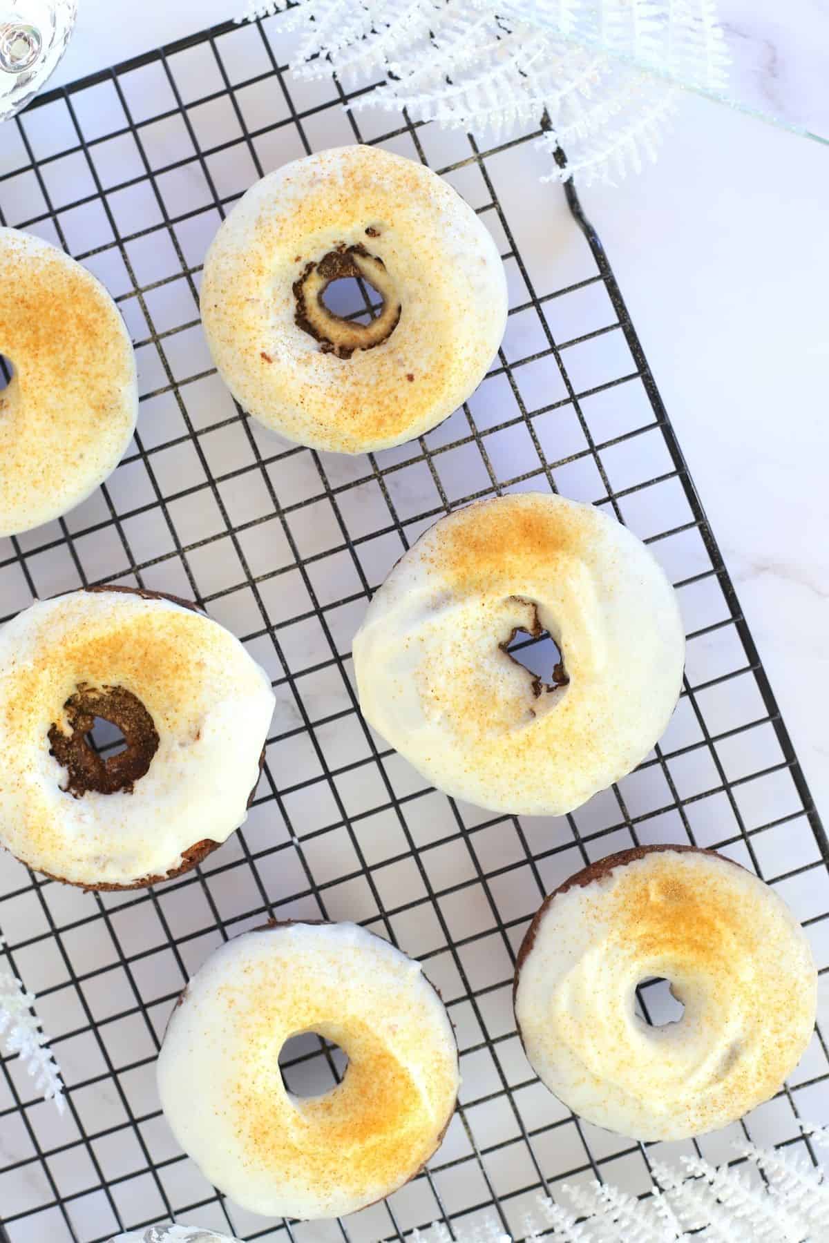 Keto Gingerbread Donuts with Cream Cheese Icing on a cooling rack