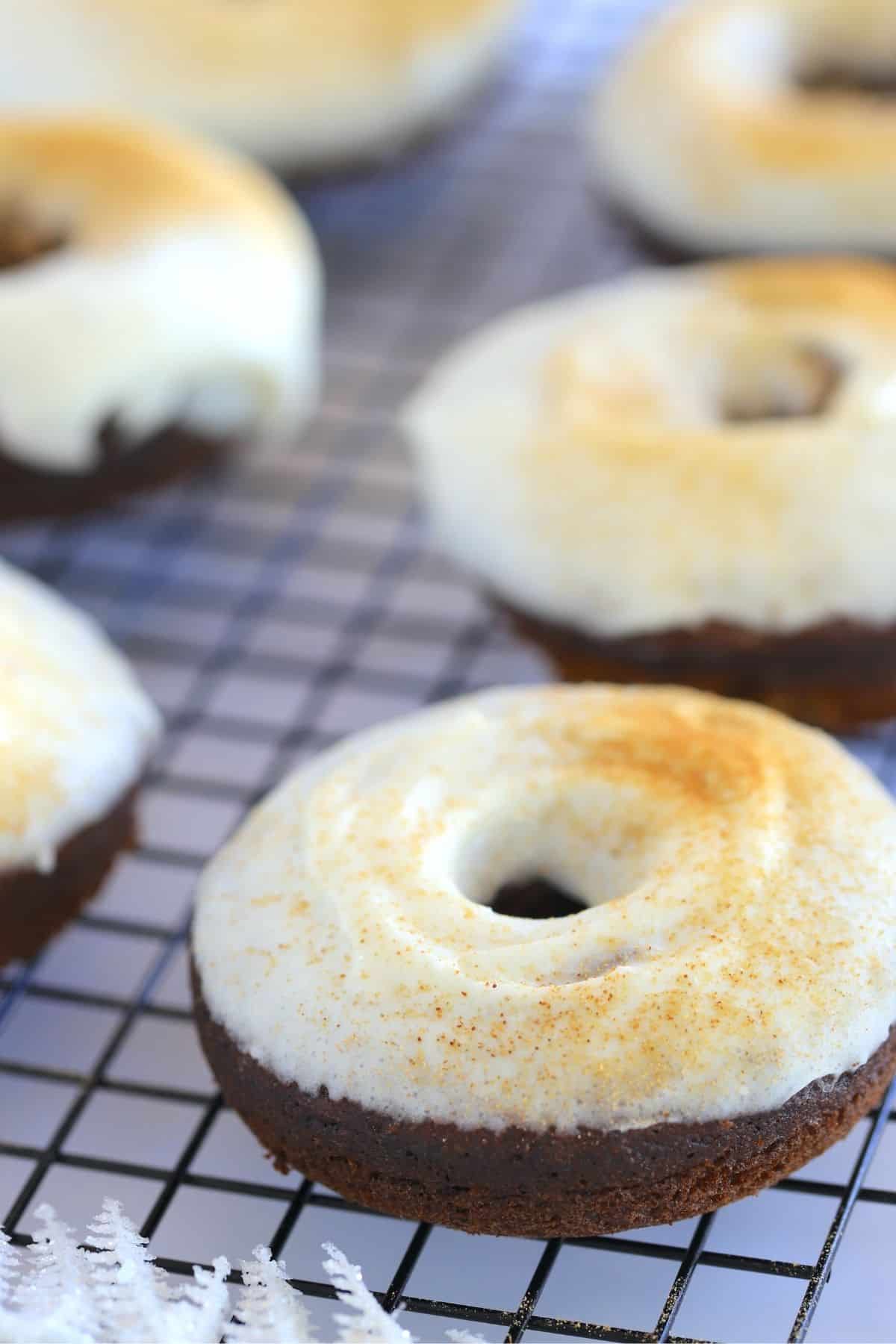 Keto Gingerbread Donuts with Cream Cheese Icing on a cooling rack