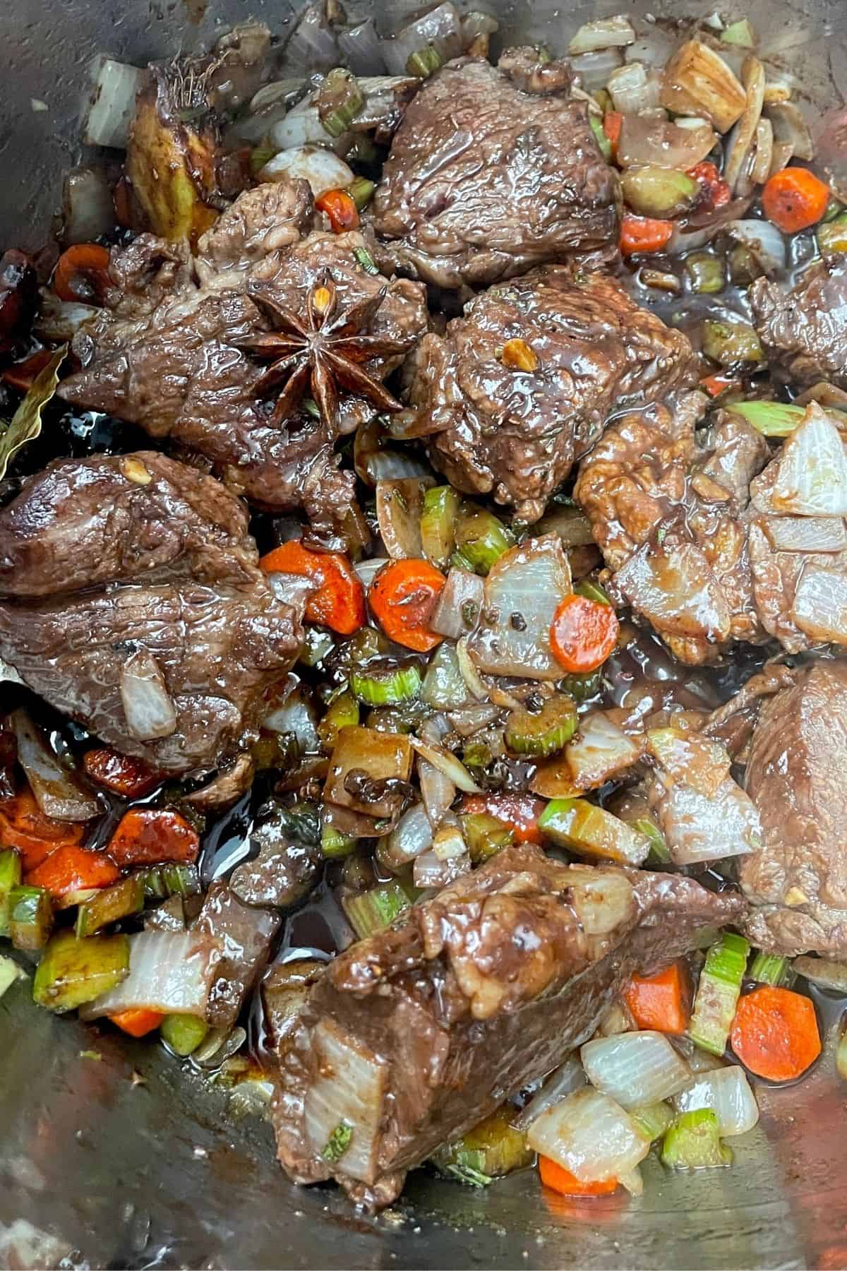 braised short ribs with star anise, carrots, celery and onion
