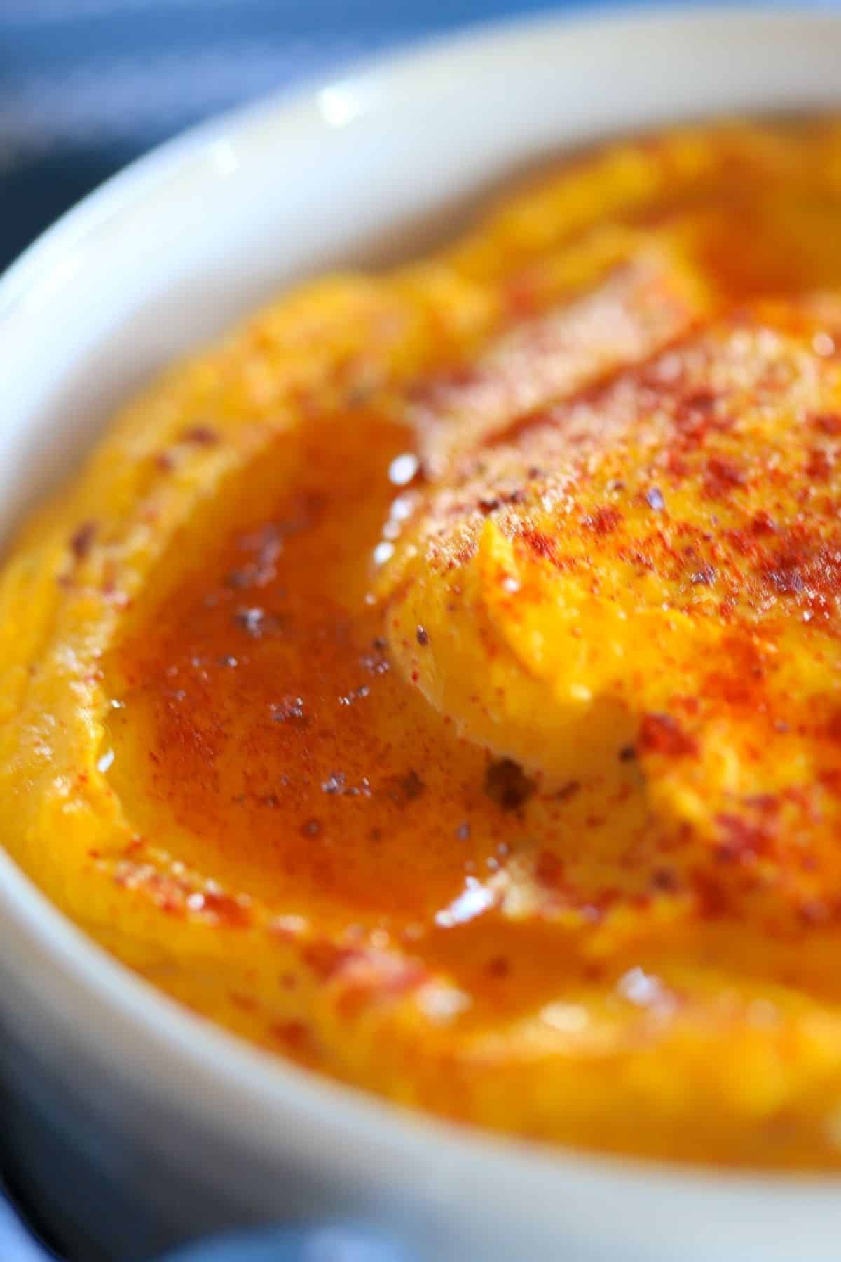 bowl of kabocha hummus topped with paprika and olive oil