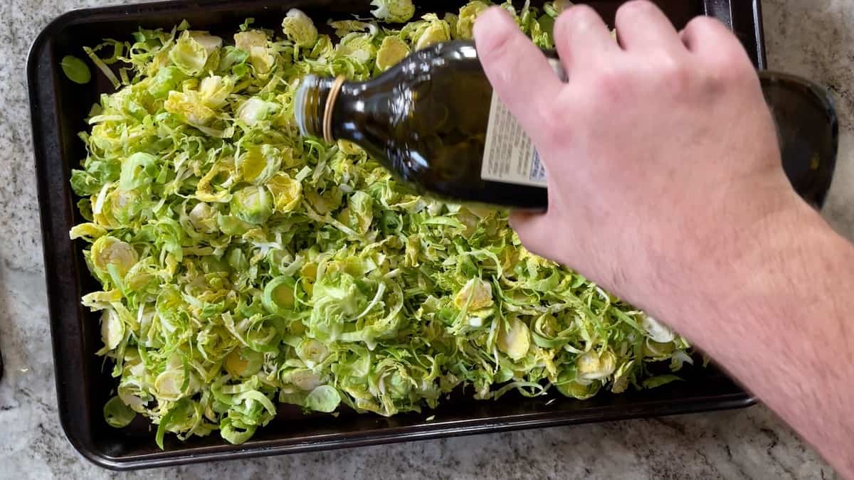 drizzling olive oil over the uncooked brussel sprouts