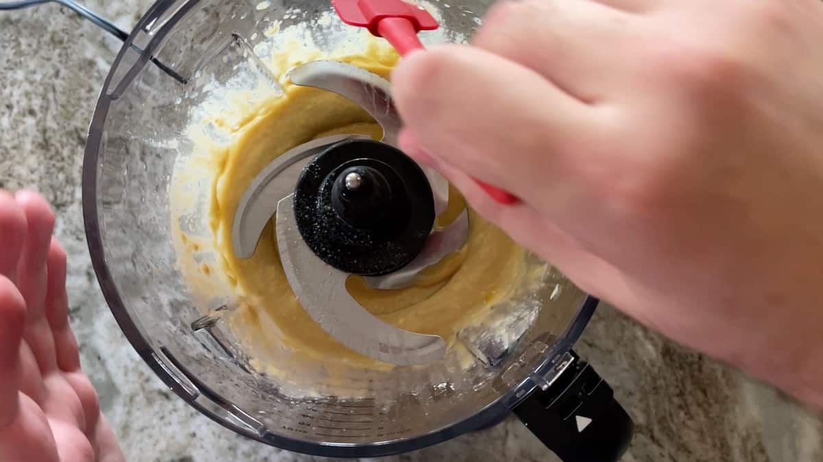 scraping down sides of food processor bowl