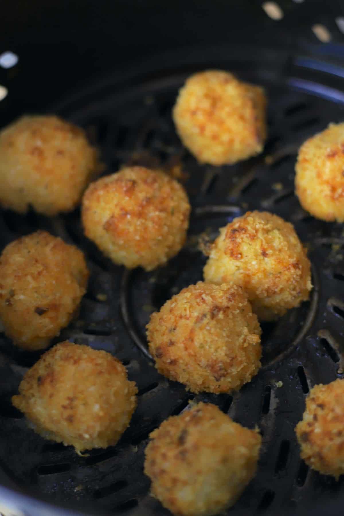 fried cauliflower balls in the air fryer basket