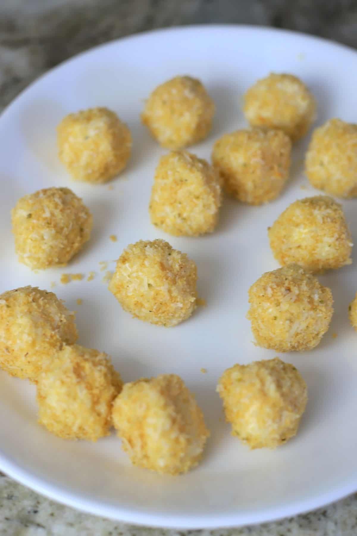 plate of uncooked breaded cauliflower balls