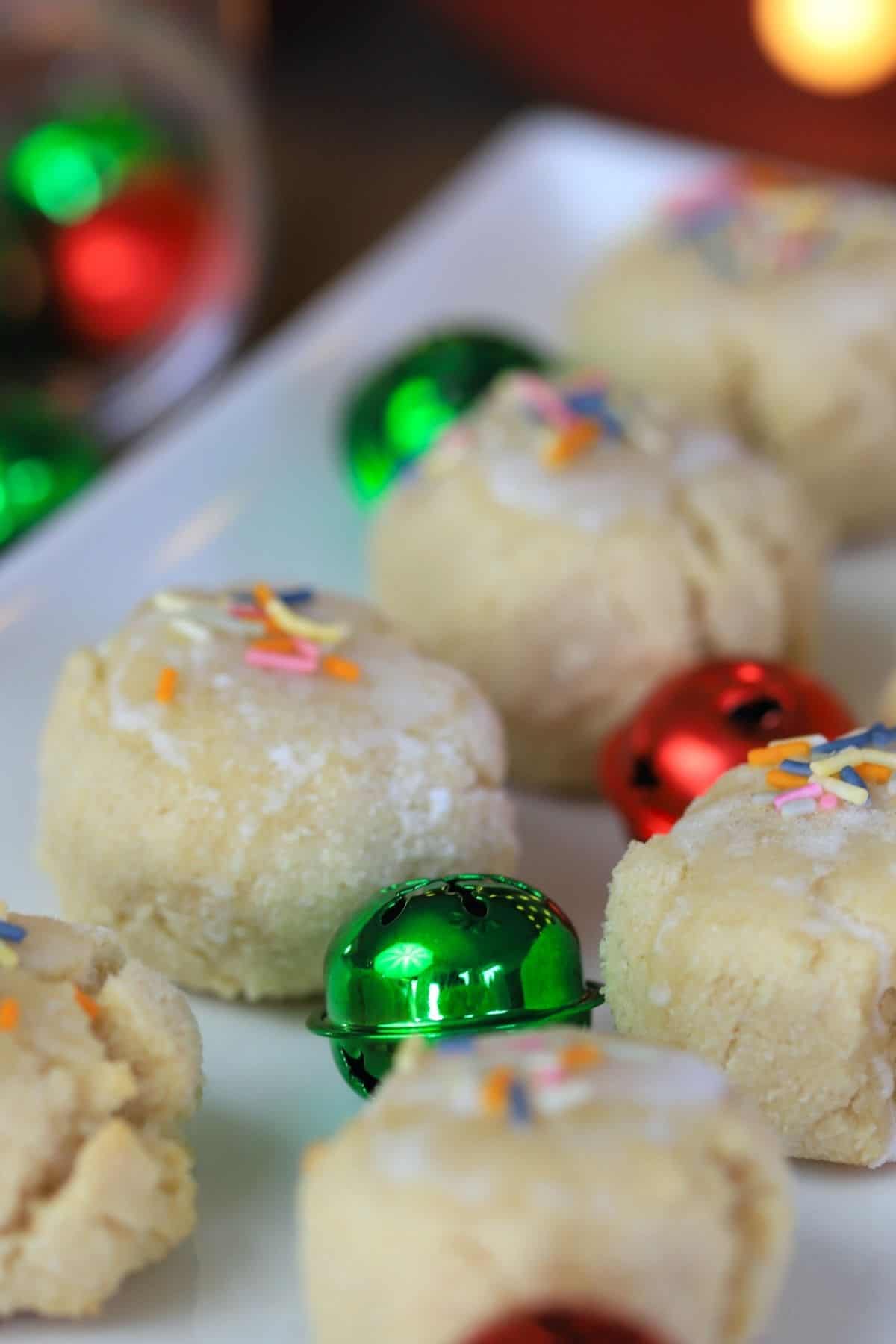 keto italian anise christmas cookies on a white platter with green and red bells