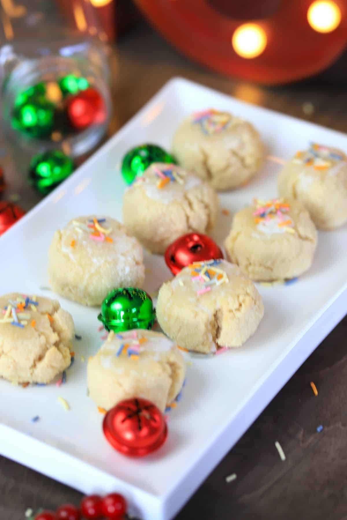 keto italian anise christmas cookies on a white platter with green and red bells
