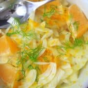 fennel citrus salad in a white bowl with a spoon