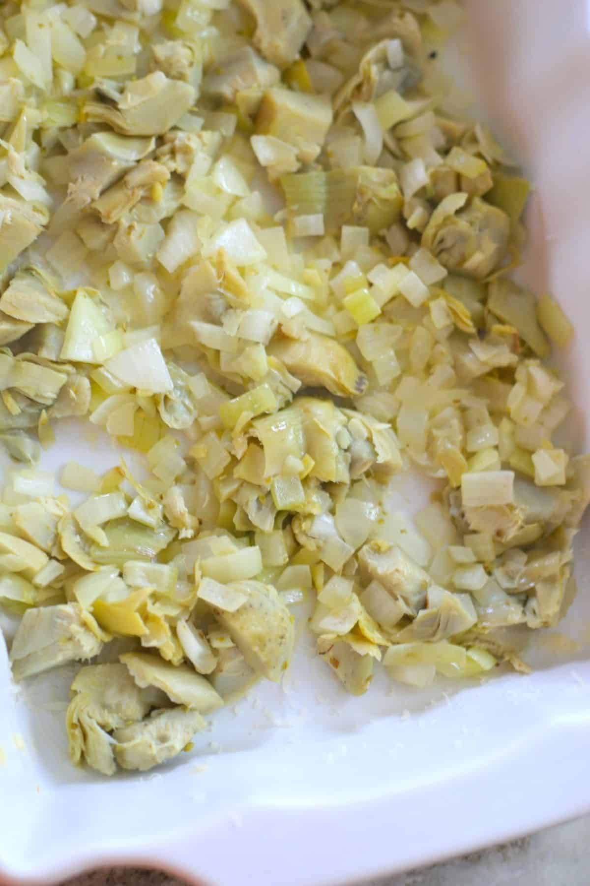 artichoke and onion mixture in the casserole dish