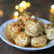marinated mozzarella balls stacked on a white bowl