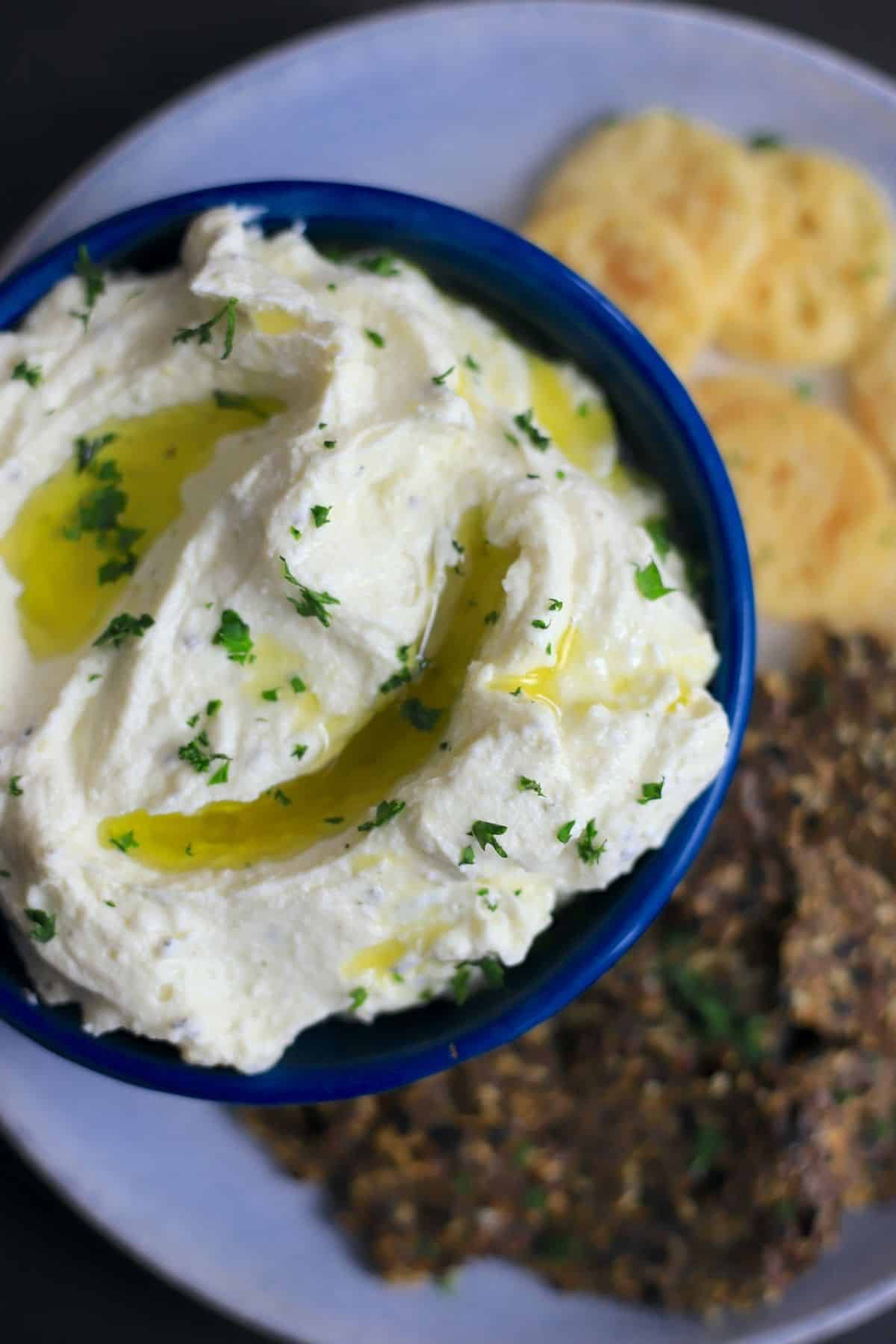 bowl of whipped cheese dip with crackers.