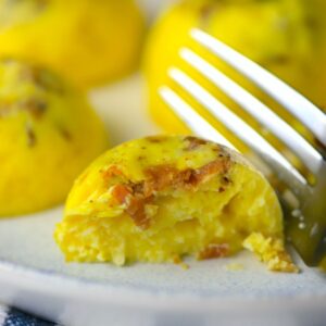 egg bites on a white dish with a fork