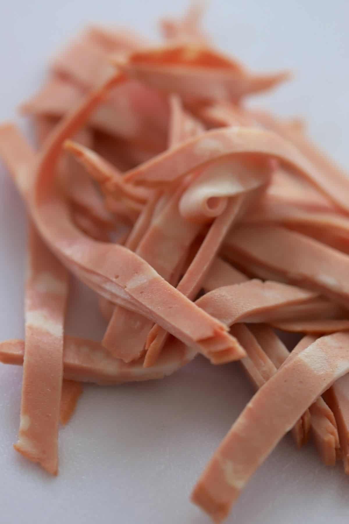 stack of mortadella sliced in ribbons.