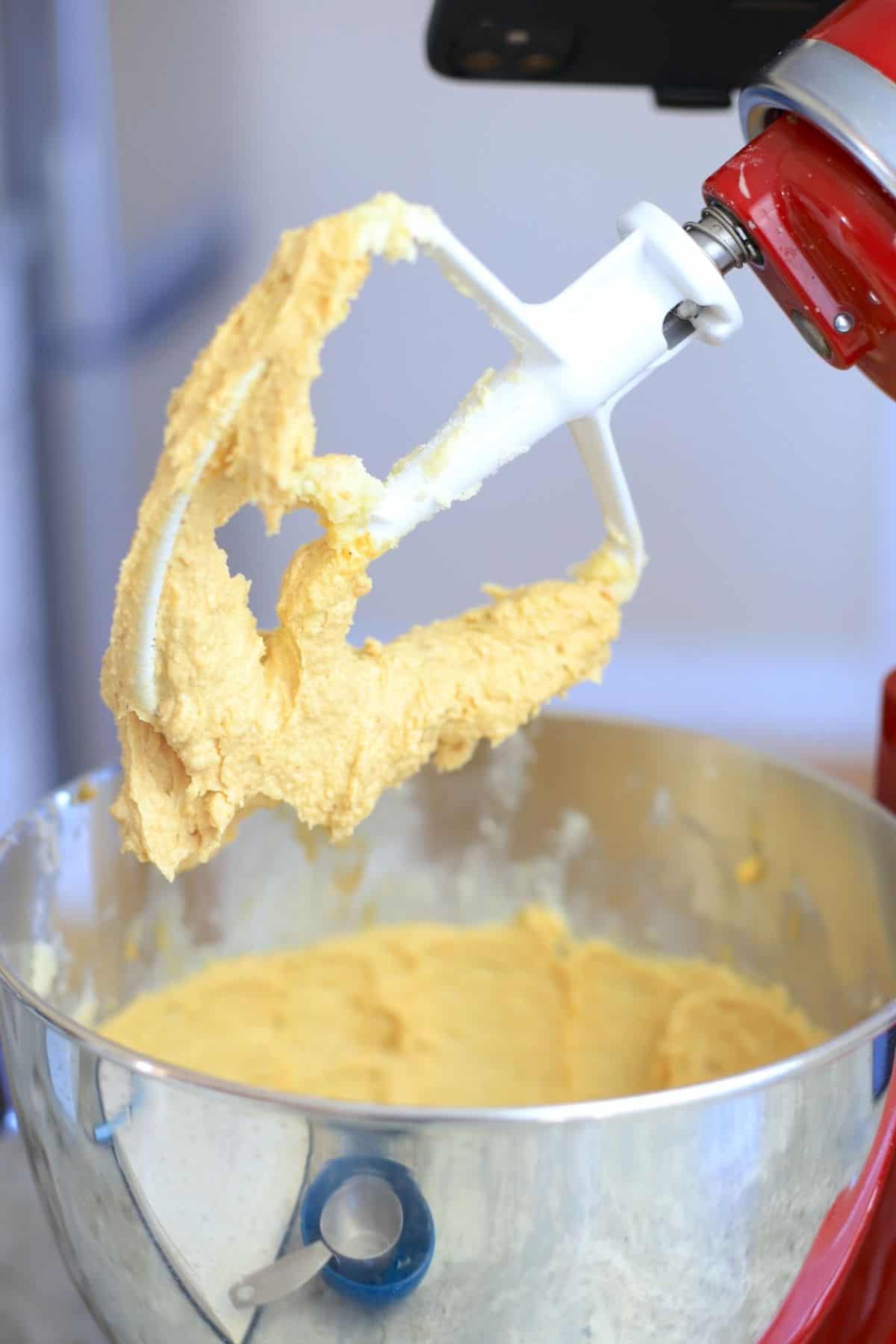 stand mixer with paddle full of cookie dough batter.
