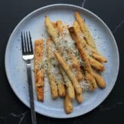garlic parmesan keto fries on a plate with a fork.