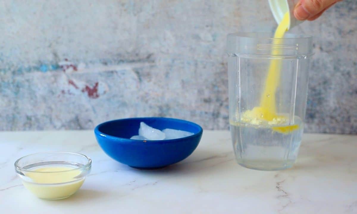 adding electrolyte powder to the blender cup.