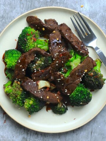 overhead shot of plate of beef and broccoli with a fork.