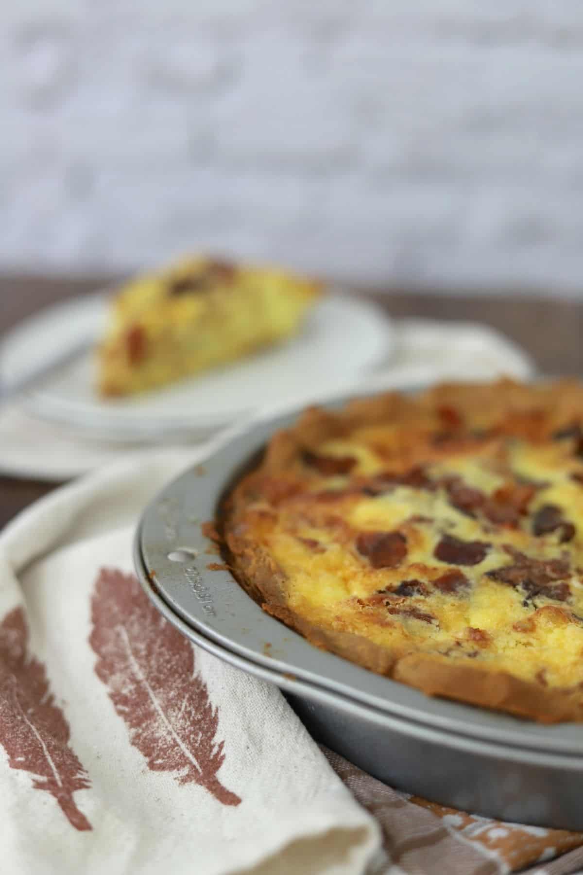 keto quiche lorraine next to slice on a plate.