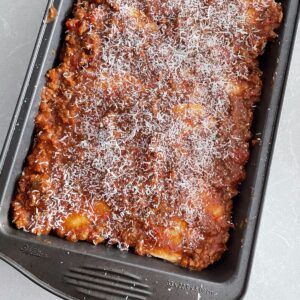 low carb lasagna in pan dusted with parmasean cheese.